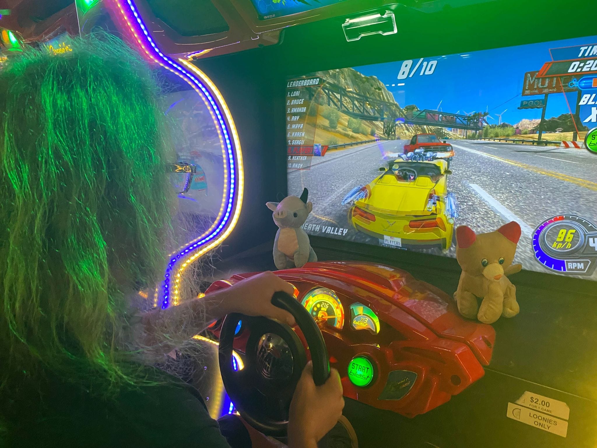 A man with green hair plays a modern driving game, Photo 6